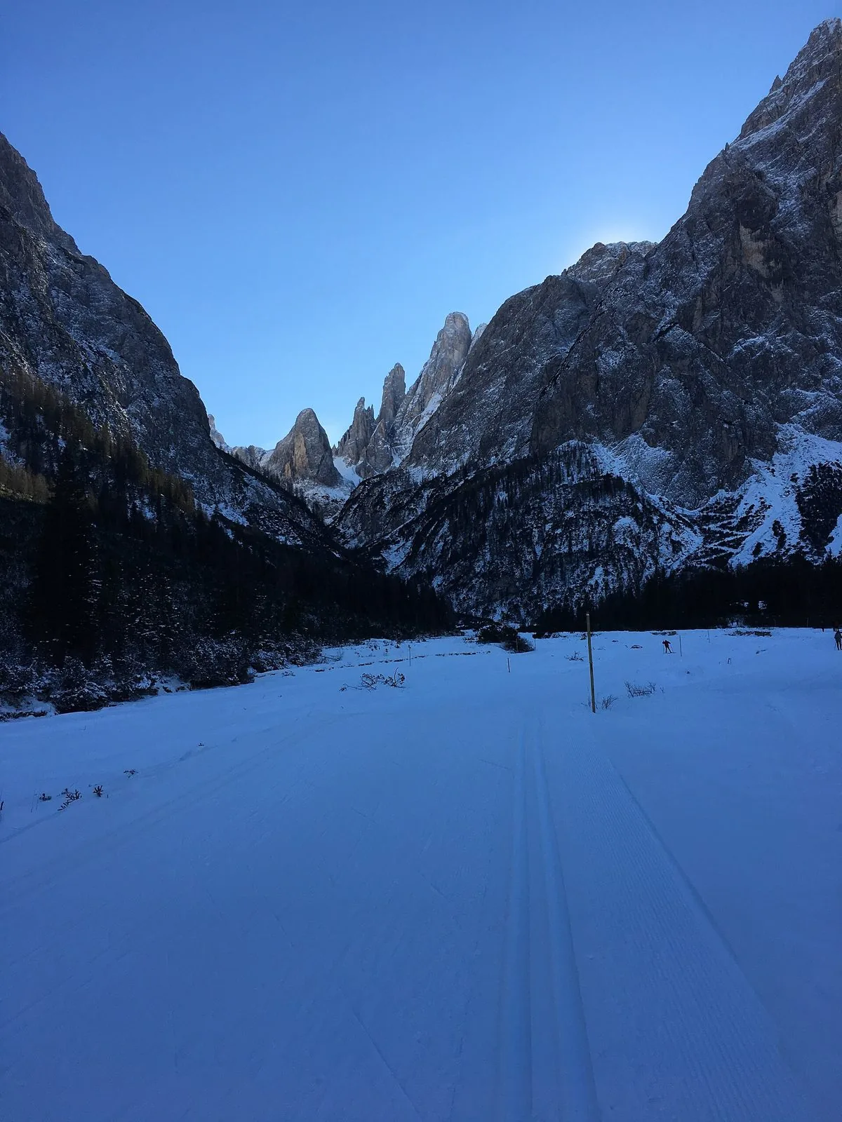 Pista di sci di fondo battuta con i binari della tecnica classica in una valle innevata delle Dolomiti di Sesto